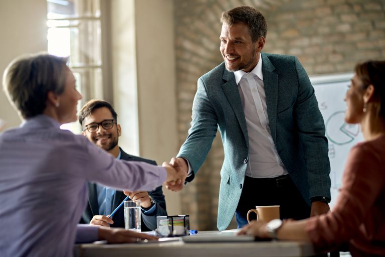 business-coworkers-shaking-hands-meeting-office-focus-is-businessman